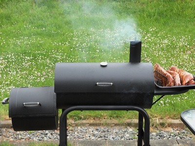 Backyard barbequing on a charcoal smoker