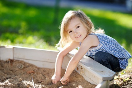 Adorable girl playing in a sandbox